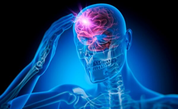 A 3D medical illustration of a transparent blue human silhouette with a glowing red brain and bright electric-like flashes at the temple to signify a traumatic brain injury.